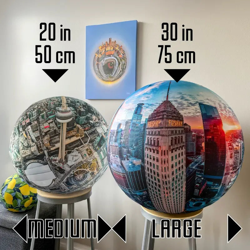 Two globes, one medium of Toronto and one large of Minneapolis, with aerial cityscape designs.